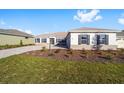 Single-story house with a two-car garage and manicured lawn at 9739 Sw 79Th Lane Rd, Ocala, FL 34481