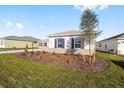 Single-story house with a two-car garage and well-maintained landscaping at 9739 Sw 79Th Lane Rd, Ocala, FL 34481