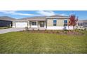 Single-story house with landscaped yard and two-car garage at 9757 Sw 79Th Lane Rd, Ocala, FL 34481