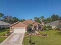Single-story home with a large backyard and driveway at 12152 Se 91St Ave, Summerfield, FL 34491