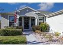 Welcoming front entrance with a decorative door and nicely landscaped area at 15750 Sw 11Th Court Rd, Ocala, FL 34473