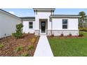 Modern front entrance with stone accents and landscaping at 566 Marion Oaks Blvd, Ocala, FL 34473