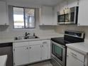 Kitchen with stainless steel appliances and white cabinets at 10865 Sw 78Th Ct, Ocala, FL 34476