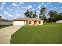 Single-story house with a light-yellow exterior, a red front door, and a neatly kept lawn at 16690 Sw 50Th Ave, Ocala, FL 34473