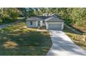 Newly built home featuring a gray garage and modern facade at 4 Oak Cir, Ocala, FL 34472