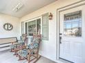 Relaxing front porch with rocking chairs and view of yard at 5226 Nw 21St Loop, Ocala, FL 34482