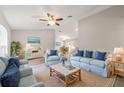 Bright living room with light blue sofas, coffee table, and large windows at 7735 Sw 148Th St, Ocala, FL 34473