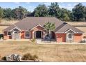 Ranch-style home with tile roof, large yard, and partial fence at 9901 Nw 6Th Ct, Ocala, FL 34475