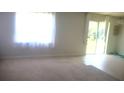 Bright living room with carpet flooring, large window, and sliding glass doors at 1609 Chelsea Manor Cir, Deland, FL 32724