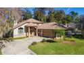 Two-story house with a two-car garage and a spacious yard surrounded by trees at 1825 Se 36Th Pl, Ocala, FL 34471