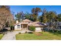 Two-story house with a large backyard, driveway, and beautiful landscaping at 1825 Se 36Th Pl, Ocala, FL 34471