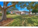 Ranch-style home with lush landscaping and a spacious yard at 8478 Sw 60Th Ct, Ocala, FL 34476