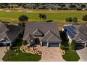Bird's-eye view of a single Gathering home with a golf course in the background at 9551 Sw 70Th Loop, Ocala, FL 34481