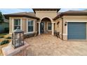 Inviting front entry with a stone walkway and charming landscaping at 9551 Sw 70Th Loop, Ocala, FL 34481