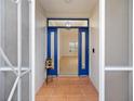 Inviting entryway with blue door and terracotta tile flooring at 9593 Sw 196Th Avenue Rd, Dunnellon, FL 34432