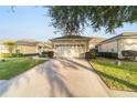 Two-car garage with driveway and manicured lawn at 9570 Sw 70Th Loop, Ocala, FL 34481