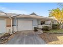 House exterior showcasing a white garage door and neat landscaping at 9756 Sw 94Th Ter # B, Ocala, FL 34481