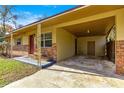 Carport with decorative supports and a paved driveway leading to the front door at 2700 Se 8Th Ave, Ocala, FL 34471