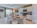 Modern kitchen with granite countertops, white cabinets, and a large island at 8864 Sw 48Th Ave, Ocala, FL 34476