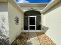 Covered entryway with decorative screen and a pathway leading to the front door at 16304 Sw 12Th Ter, Ocala, FL 34473