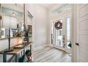 Bright and airy entryway with wood-look floors and a stylish console table at 4522 Shockoe Cir, The Villages, FL 32163