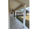 Covered front porch with tiled flooring and columns leading to the front door at 75 Pine Crse, Ocala, FL 34472