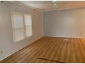 Spacious living room with light gray walls and wood-look flooring at 927 Weeping Willow Ave, Lady Lake, FL 32159