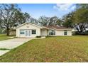 Single-story house with a brown roof, double doors and large windows at 14136 Sw 8Th Ave, Ocala, FL 34473