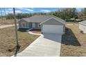 Elevated view of a gray, single-story home with attached garage at 281 Locust Pass, Ocala, FL 34472