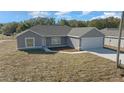 Elevated view of a gray, single-story home with attached garage at 281 Locust Pass, Ocala, FL 34472