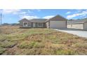 New construction home with a one-car garage and a large front yard at 281 Locust Pass, Ocala, FL 34472