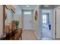 Welcoming entryway with stylish decor and a view into a bedroom at 328 Hickory Course Trl, Ocala, FL 34472