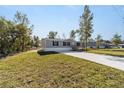 Gray manufactured home on a grassy lot with a concrete driveway at 18478 Se 58Th Pl, Ocklawaha, FL 32179