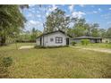 Front view of a house with a grassy yard and decorative accents at 5238 Nw 61St Ln, Ocala, FL 34482