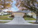Attractive home exterior with a two-car garage and landscaped yard at 7102 Sw 91St Ct, Ocala, FL 34481