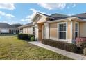 Inviting front yard landscaping leads to a covered entryway at 7102 Sw 91St Ct, Ocala, FL 34481