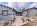 Gray house with a brick pathway leading to the entrance at 10120 Sw 49Th Ave, Ocala, FL 34476