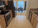 Kitchen with stainless steel appliances and view of dining area at 10913 Sw 69Th Cir, Ocala, FL 34476