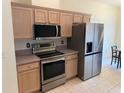 Stainless steel appliances and light wood cabinets highlight this kitchen at 10913 Sw 69Th Cir, Ocala, FL 34476