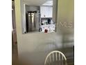 View into kitchen from dining area. Stainless steel appliances are visible at 548 Fairways Dr # B, Ocala, FL 34472