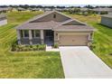 One-story home with tan siding, brown roof, and landscaped yard at 6243 Sw 89Th Street Rd, Ocala, FL 34476
