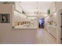 Bright kitchen with white cabinets, tile floor, and island at 8225 Sw 108Th Loop, Ocala, FL 34481