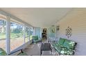 Relaxing screened porch with seating and view of backyard at 8225 Sw 108Th Loop, Ocala, FL 34481