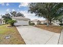 House exterior with a driveway and landscaping at 9646 Sw 92 Place Rd, Ocala, FL 34481