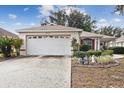 Single story house with white garage door and landscaping at 9646 Sw 92 Place Rd, Ocala, FL 34481