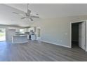 Modern kitchen with gray cabinets, granite countertops, and stainless steel appliances at 115 Guava Place Dr, Ocklawaha, FL 32179