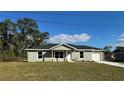 Newly built home with gray exterior, white garage door, and stone accents at 16919 Sw 27Th Ave, Ocala, FL 34473