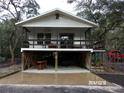 Front view of an elevated home with a covered porch and parking underneath at 17935 Se 10Th Pl, Silver Springs, FL 34488