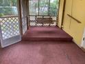 Screened porch with a swing and carpet flooring at 1855 Ne 23Rd St, Ocala, FL 34470