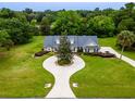 Aerial view of house showcasing unique driveway and landscaping at 1945 Sw 40Th Pl, Ocala, FL 34471